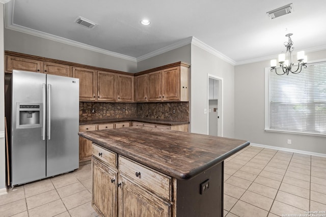 25233 Battle Lk, San Antonio, TX 78260 - kitchen with stainless steel refrigerator with ice dispenser, dark countertops, light tile patterned floors, a chandelier, and ornamental molding