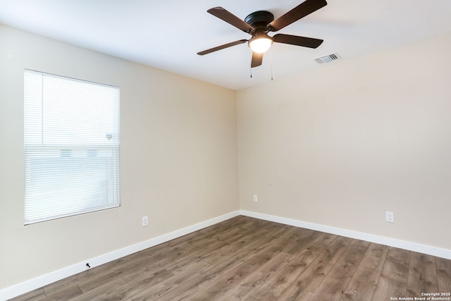 239 Surrey, San Antonio, TX 78225 - unfurnished room with wood finished floors, a ceiling fan, and baseboards