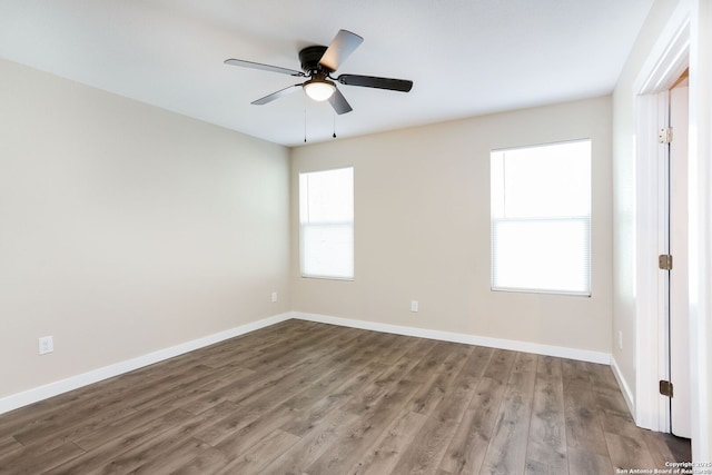239 Surrey, San Antonio, TX 78225 - empty room with wood finished floors, ceiling fan, and baseboards