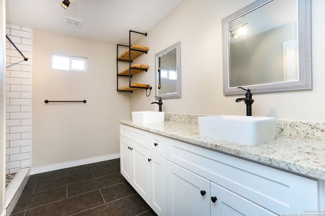 239 Surrey, San Antonio, TX 78225 - full bathroom featuring double vanity, tile patterned floors, a tile shower, and baseboards