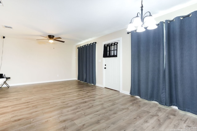 239 Surrey, San Antonio, TX 78225 - unfurnished living room featuring light wood-type flooring, a ceiling fan, a chandelier, and baseboards