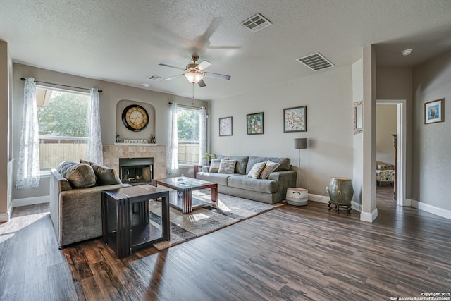 214 Ridge Blf, Cibolo, TX 78108 - living room with plenty of natural light, dark wood-style floors, ceiling fan, a textured ceiling, and baseboards