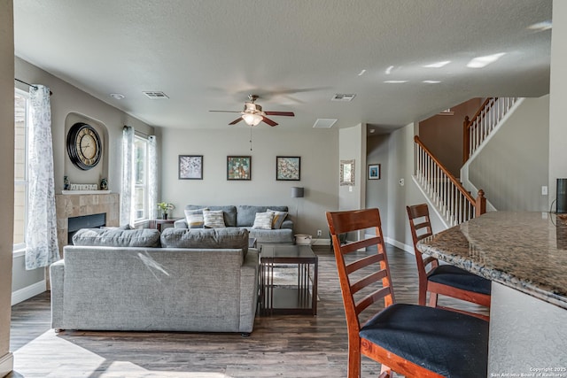 214 Ridge Blf, Cibolo, TX 78108 - living area featuring ceiling fan, dark wood finished floors, stairs, baseboards, and a textured ceiling