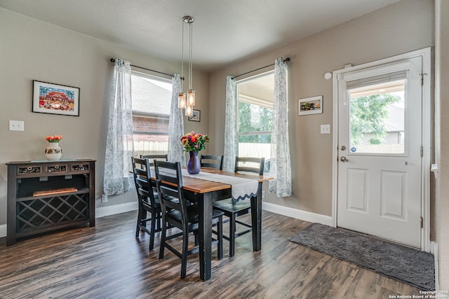 214 Ridge Blf, Cibolo, TX 78108 - dining area featuring dark wood-style flooring, baseboards, and a chandelier