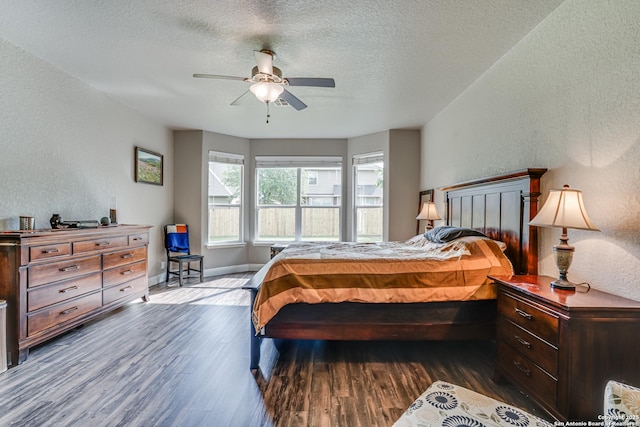 214 Ridge Blf, Cibolo, TX 78108 - bedroom featuring a textured wall, wood finished floors, a textured ceiling, baseboards, and a ceiling fan