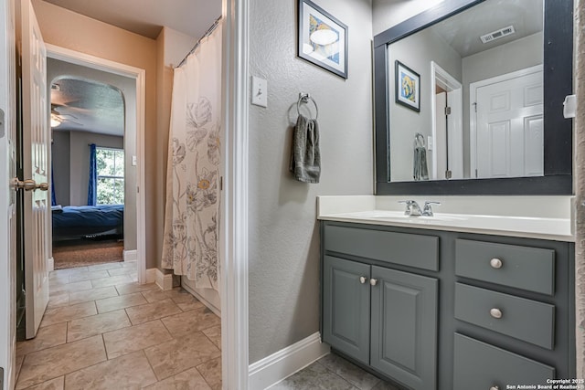 214 Ridge Blf, Cibolo, TX 78108 - ensuite bathroom featuring baseboards, vanity, a ceiling fan, and a shower with shower curtain
