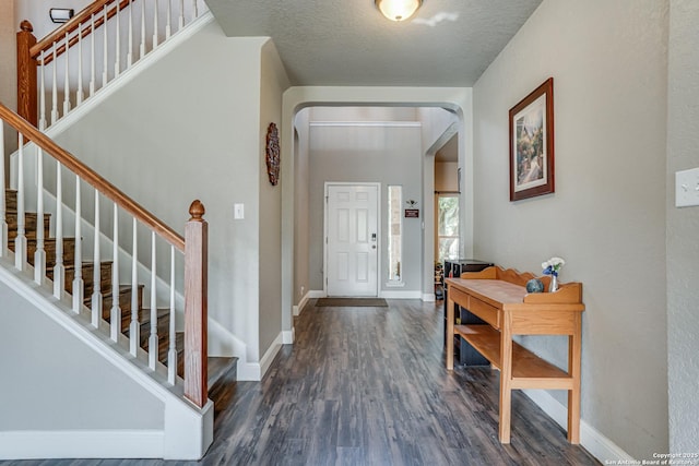 214 Ridge Blf, Cibolo, TX 78108 - foyer entrance featuring arched walkways, wood finished floors, baseboards, and stairs