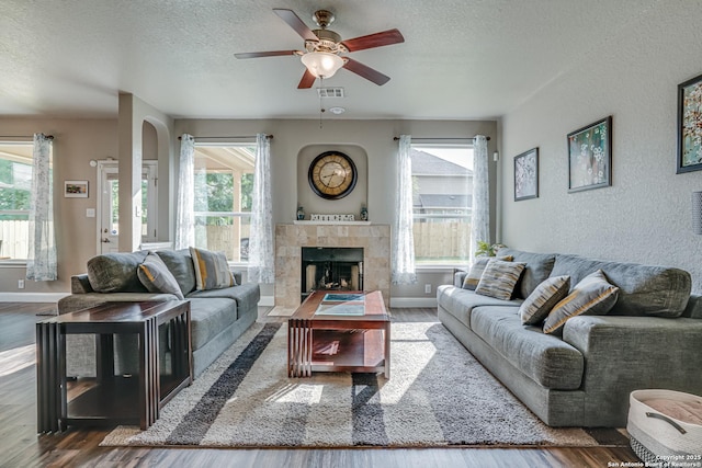 214 Ridge Blf, Cibolo, TX 78108 - living room with a textured ceiling, wood finished floors, plenty of natural light, ceiling fan, and a textured wall
