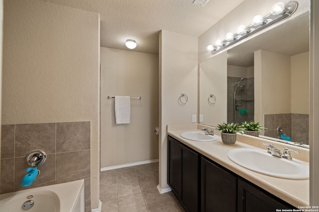 184 Jolie Cir, Boerne, TX 78015 - bathroom with tile patterned flooring, a garden tub, double vanity, a textured ceiling, and a shower