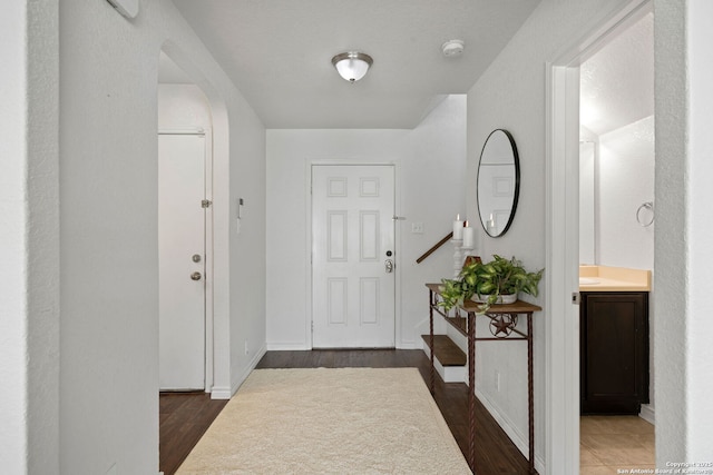 184 Jolie Cir, Boerne, TX 78015 - corridor featuring dark wood-style flooring, stairs, and baseboards