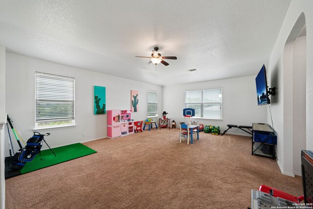 184 Jolie Cir, Boerne, TX 78015 - game room featuring ceiling fan, carpet, arched walkways, baseboards, and a textured ceiling