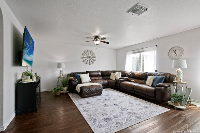 184 Jolie Cir, Boerne, TX 78015 - living area with baseboards, dark wood-style flooring, a ceiling fan, and a textured ceiling