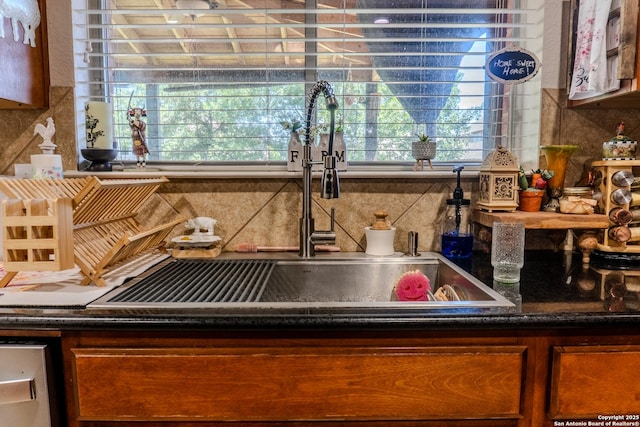 3351 Highline Trl, San Antonio, TX 78261 - kitchen view of a sink, backsplash, and dark countertops