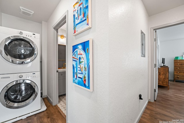 351 Barbara, San Antonio, TX 78216 - washroom with stacked washer / drying machine, wood finished floors, electric panel, baseboards, and a textured wall