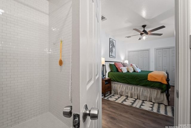 351 Barbara, San Antonio, TX 78216 - bedroom featuring two closets, wood finished floors, and ensuite bath