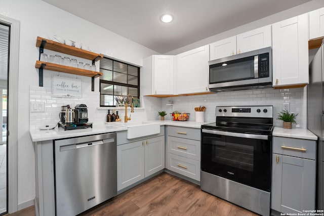351 Barbara, San Antonio, TX 78216 - kitchen with stainless steel appliances, gray cabinets, a sink, decorative backsplash, and healthy amount of natural light