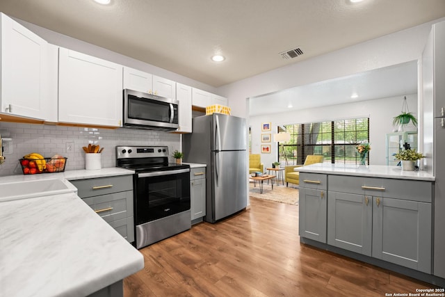 351 Barbara, San Antonio, TX 78216 - kitchen featuring appliances with stainless steel finishes, light countertops, gray cabinetry, backsplash, and a sink