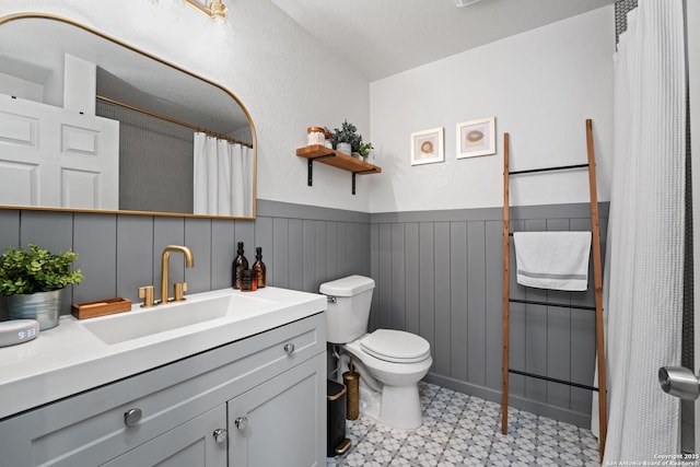 351 Barbara, San Antonio, TX 78216 - full bath with tile patterned floors, toilet, a wainscoted wall, and vanity