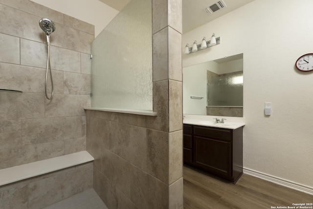 22363 Escalante Run, San Antonio, TX 78261 - full bathroom with walk in shower, wood finished floors, vanity, and baseboards