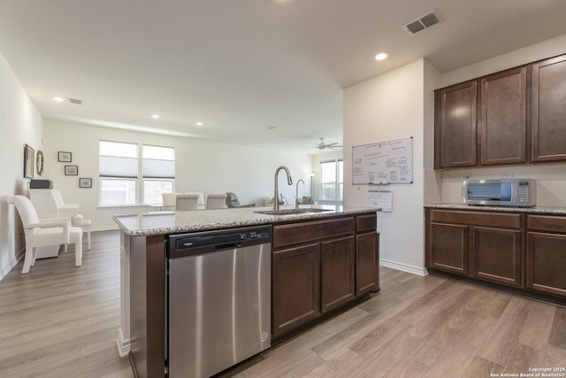 22363 Escalante Run, San Antonio, TX 78261 - kitchen featuring appliances with stainless steel finishes, a sink, light wood-style flooring, an island with sink, and recessed lighting