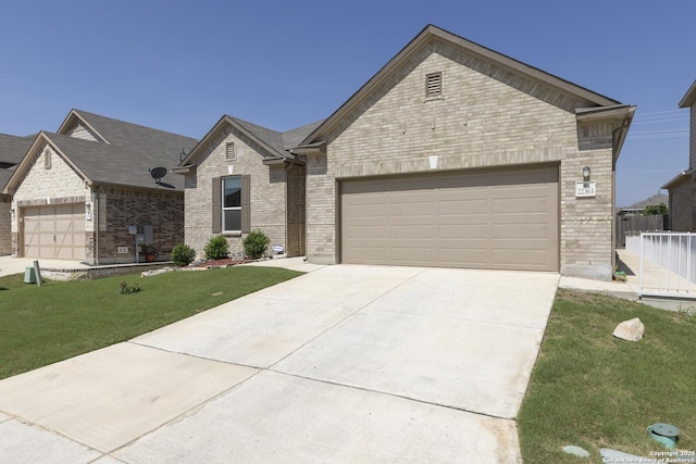 22363 Escalante Run, San Antonio, TX 78261 - view of front of home with an attached garage, driveway, a front yard, and brick siding