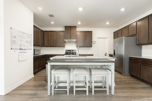 22363 Escalante Run, San Antonio, TX 78261 - kitchen featuring stainless steel appliances, a sink, under cabinet range hood, dark brown cabinets, and recessed lighting