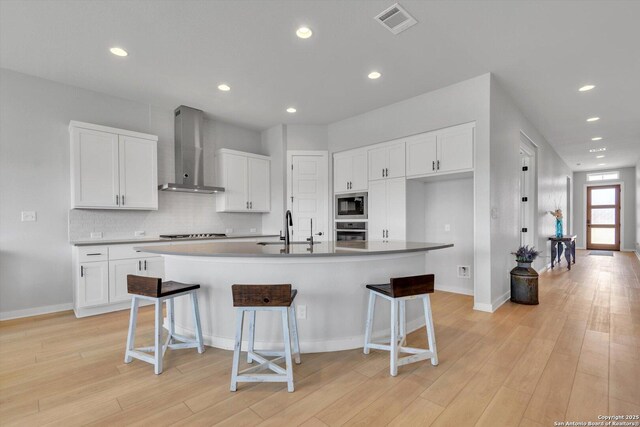 1624 Dirndl, New Braunfels, TX 78132 - kitchen with wall chimney range hood, built in microwave, stainless steel oven, black cooktop, and a sink