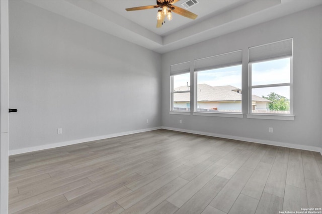1624 Dirndl, New Braunfels, TX 78132 - unfurnished room with light wood-style floors, ceiling fan, and a tray ceiling