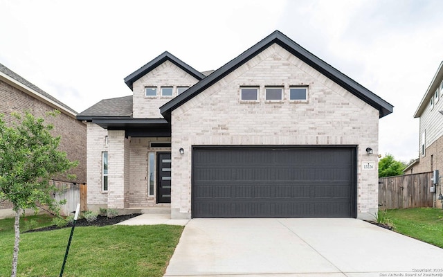 13226 Blue Flame, San Antonio, TX 78245 - french provincial home with driveway, an attached garage, stone siding, and brick siding
