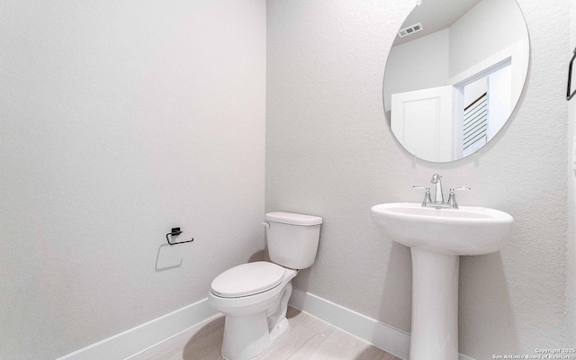 13226 Blue Flame, San Antonio, TX 78245 - bathroom with toilet, wood finished floors, and baseboards