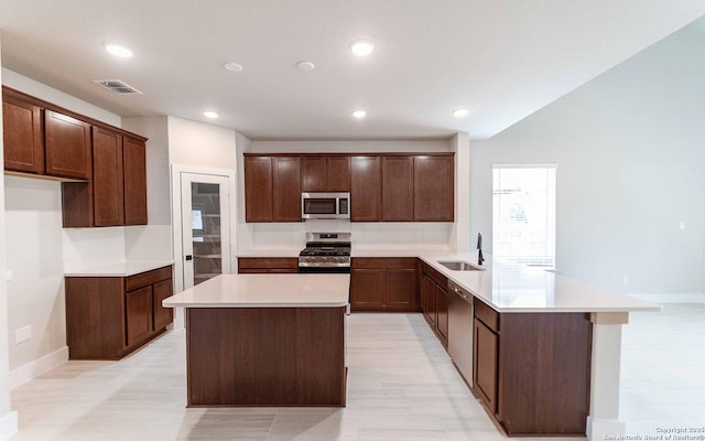 13226 Blue Flame, San Antonio, TX 78245 - kitchen with stainless steel appliances, a peninsula, a sink, a center island, and recessed lighting