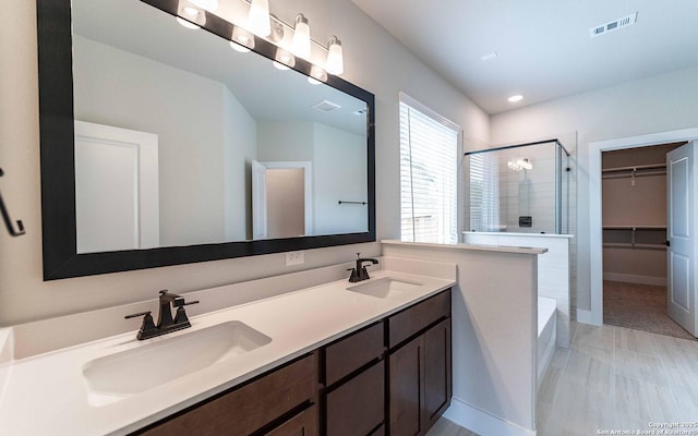 13226 Blue Flame, San Antonio, TX 78245 - full bath with a stall shower, double vanity, a bathtub, a spacious closet, and recessed lighting