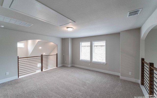 13226 Blue Flame, San Antonio, TX 78245 - carpeted empty room featuring attic access, baseboards, and arched walkways