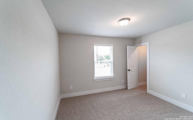 13226 Blue Flame, San Antonio, TX 78245 - empty room with light colored carpet, baseboards, and a textured ceiling