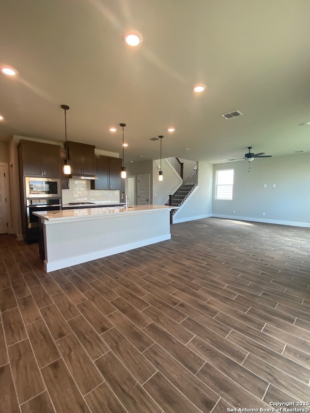 11111 Carlyle Spgs, Live Oak, TX 78233 - kitchen with dark wood-style flooring, baseboards, ceiling fan, open floor plan, and recessed lighting
