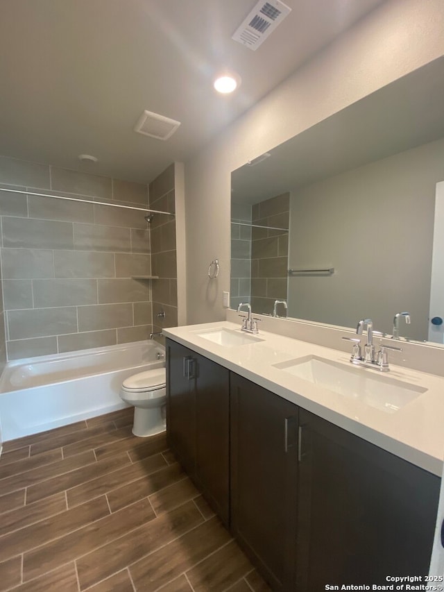 11111 Carlyle Spgs, Live Oak, TX 78233 - bathroom with toilet, wood finish floors, double vanity, and bathtub / shower combination