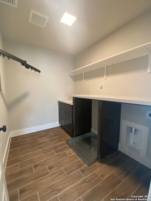 11111 Carlyle Spgs, Live Oak, TX 78233 - washroom featuring cabinet space, wood tiled floors, and baseboards
