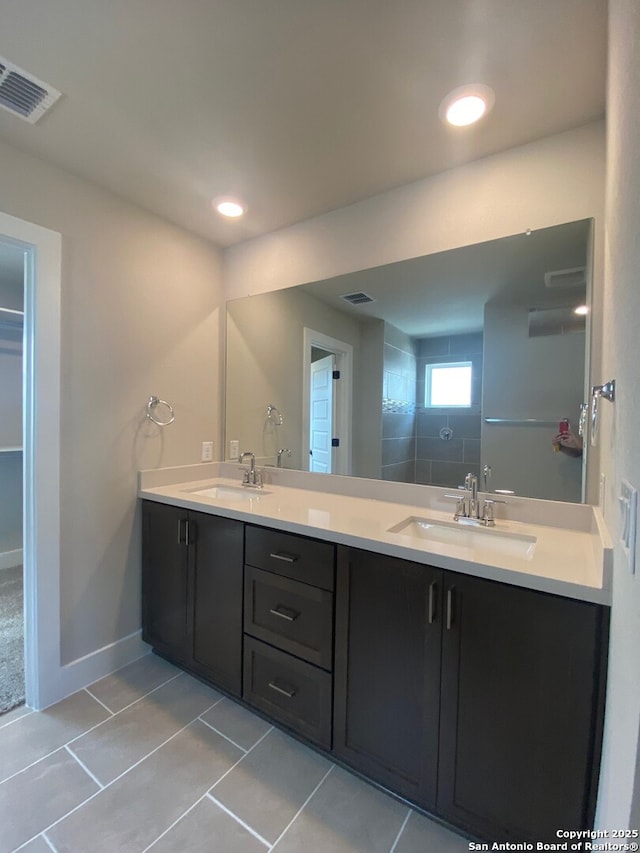 11111 Carlyle Spgs, Live Oak, TX 78233 - bathroom featuring tile patterned floors, double vanity, baseboards, and recessed lighting