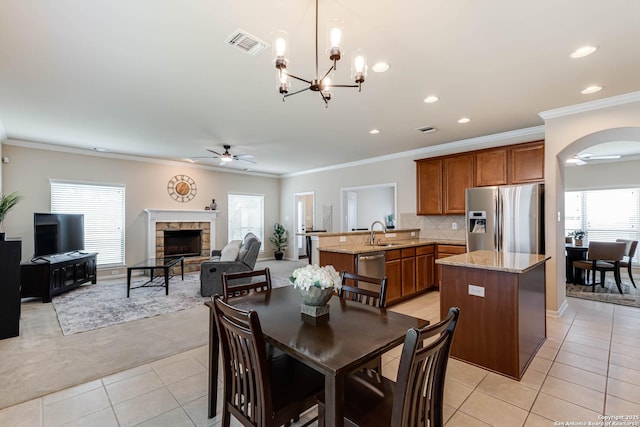 23022 Airedale Ln, San Antonio, TX 78260 - dining area featuring ceiling fan, light tile patterned floors, arched walkways, a fireplace, and recessed lighting