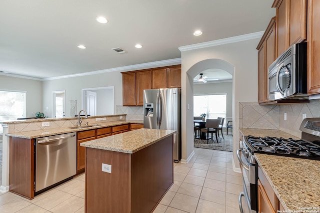 23022 Airedale Ln, San Antonio, TX 78260 - kitchen featuring appliances with stainless steel finishes, a sink, a peninsula, a center island, and arched walkways