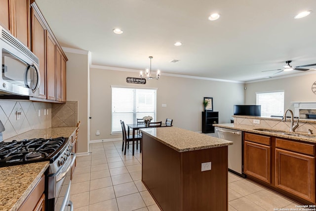 23022 Airedale Ln, San Antonio, TX 78260 - kitchen with stainless steel appliances, a center island, brown cabinetry, a sink, and a chandelier