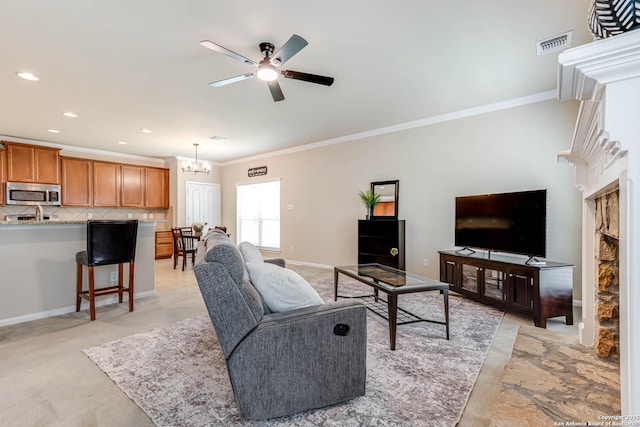 23022 Airedale Ln, San Antonio, TX 78260 - living area with crown molding, ceiling fan, a chandelier, recessed lighting, and a fireplace