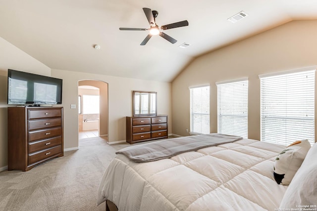 23022 Airedale Ln, San Antonio, TX 78260 - bedroom with vaulted ceiling, arched walkways, light carpet, baseboards, and a ceiling fan