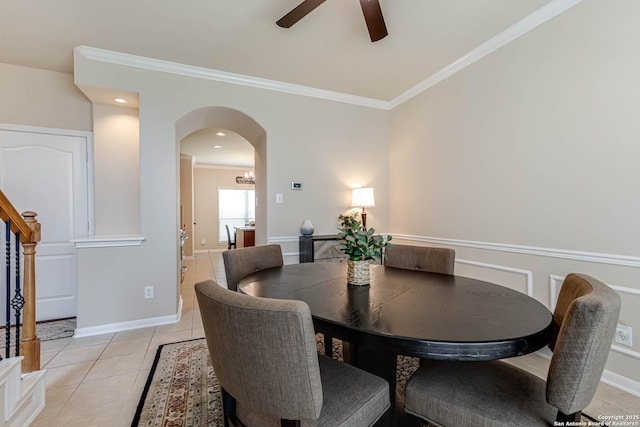 23022 Airedale Ln, San Antonio, TX 78260 - dining room with crown molding, arched walkways, ceiling fan, light tile patterned floors, and stairway