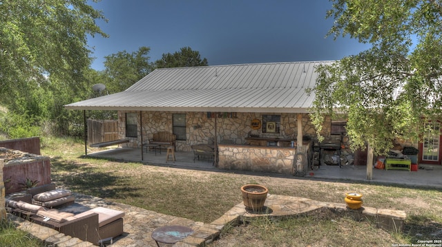 121 David Rankin Rd, Leakey, TX 78873 - rear view of property with stone siding, a patio area, and metal roof