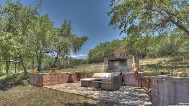 121 David Rankin Rd, Leakey, TX 78873 - view of yard featuring a patio and an outdoor living space with a fireplace