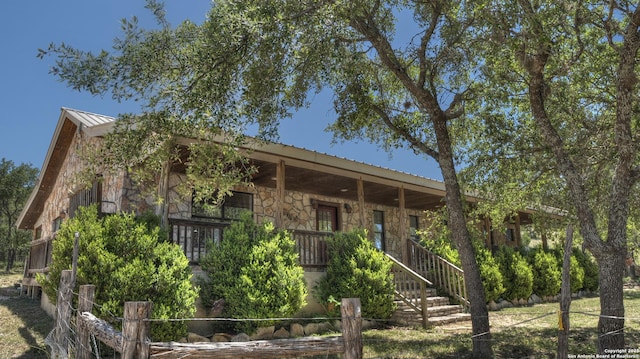 121 David Rankin Rd, Leakey, TX 78873 - view of front of home with stone siding, covered porch, metal roof, and a standing seam roof