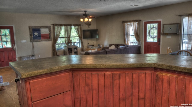 121 David Rankin Rd, Leakey, TX 78873 - kitchen featuring a ceiling fan, open floor plan, a textured ceiling, and dark countertops