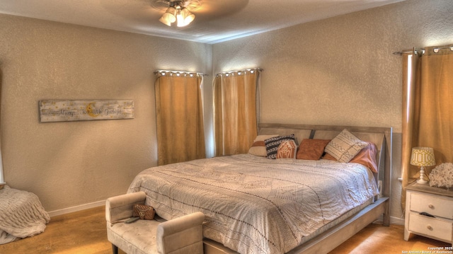 121 David Rankin Rd, Leakey, TX 78873 - bedroom with a textured wall, baseboards, and a ceiling fan