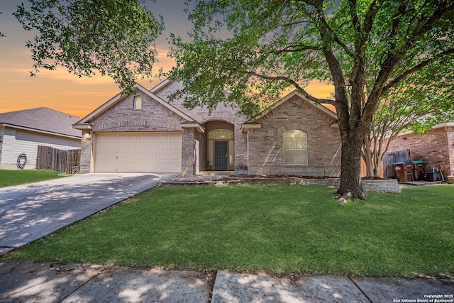 10715 Palomino, San Antonio, TX 78254 - view of front of home featuring an attached garage, driveway, a front yard, and brick siding